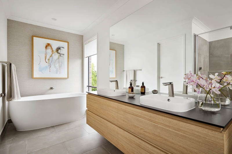 A freestanding bath and floating vanity in a Henley Home master ensuite